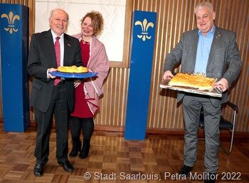 Bei der Überreichung des traditionellen "Galtte des Rois" der ehemalige französische Honorarkonsul Michel Bouchon und die amtierende Honorarkonsulin Myriam Bouchon (l) nund OB Peter Demmer (r)